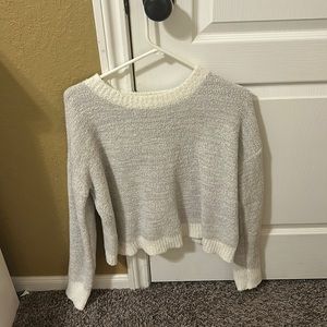 light grey sweater with white accents